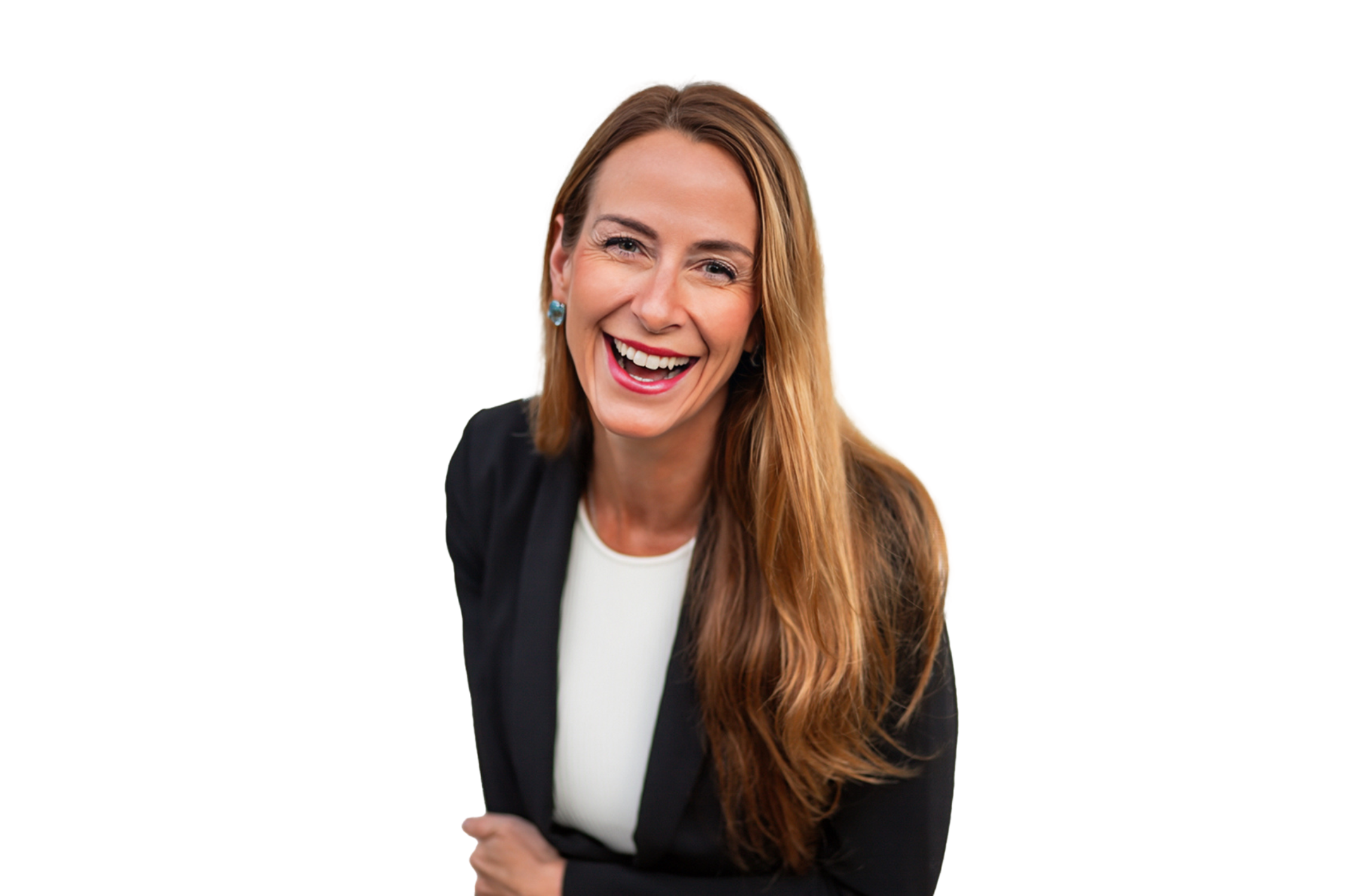 A woman with long red hair, wearing a black blazer and white top, smiling and laughing.